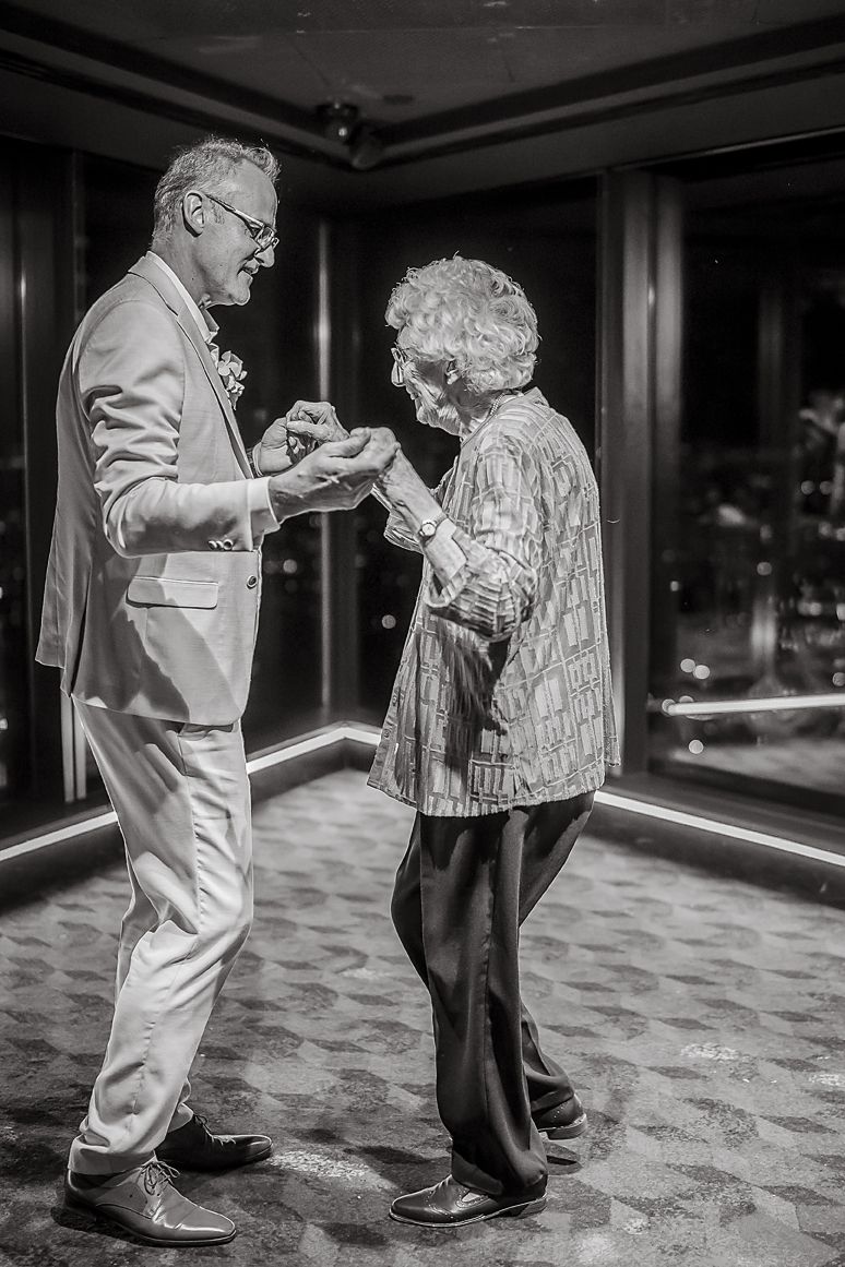A sequence of black and white images showing two people dancing gracefully together on a patterned carpet.