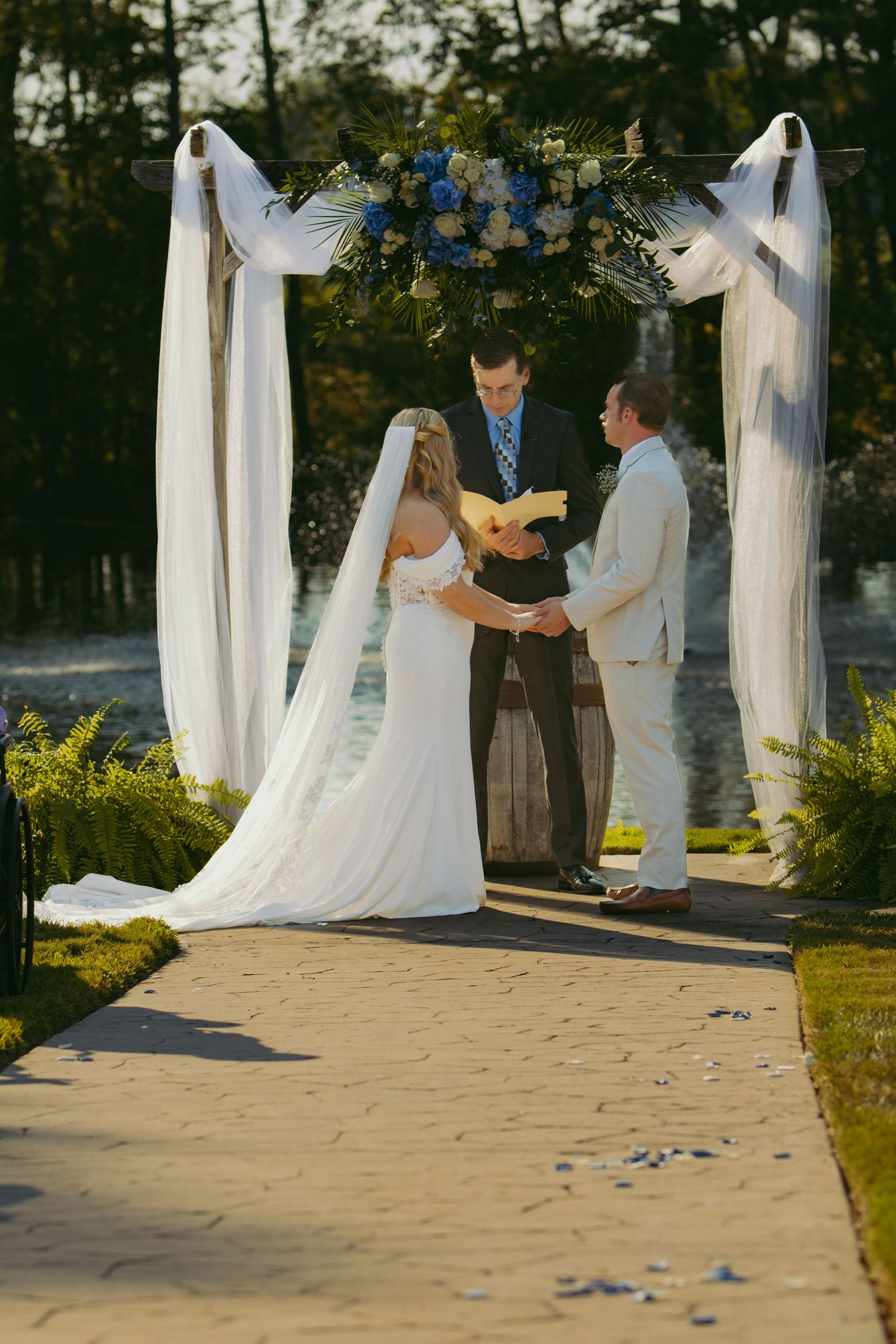 Close up of couple holding hands wearing casual and formal attire.