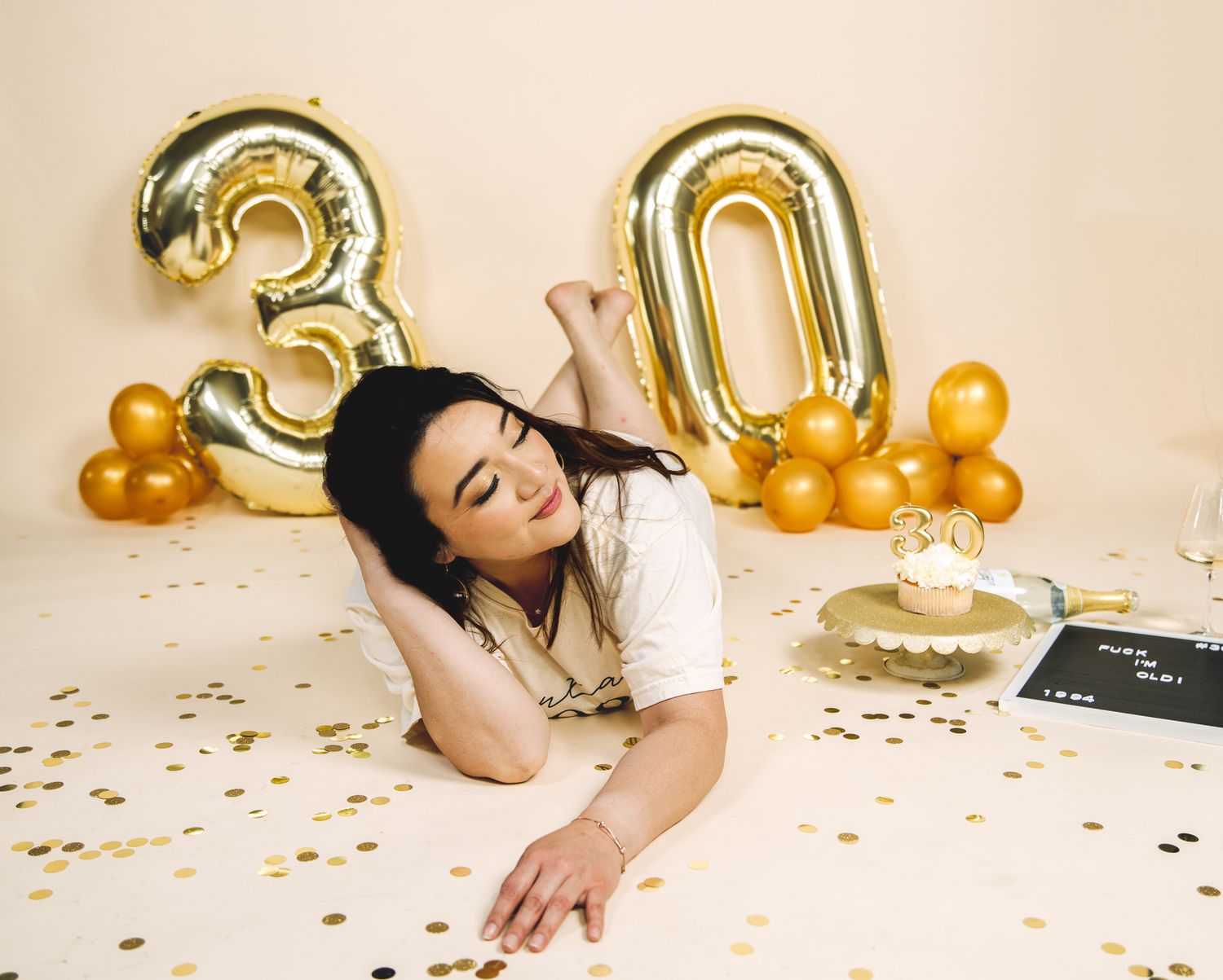 Studio birthday photoshoot of a women posing on a chair while she celebrates her 30th birthday in a Greeley Colorado studio.