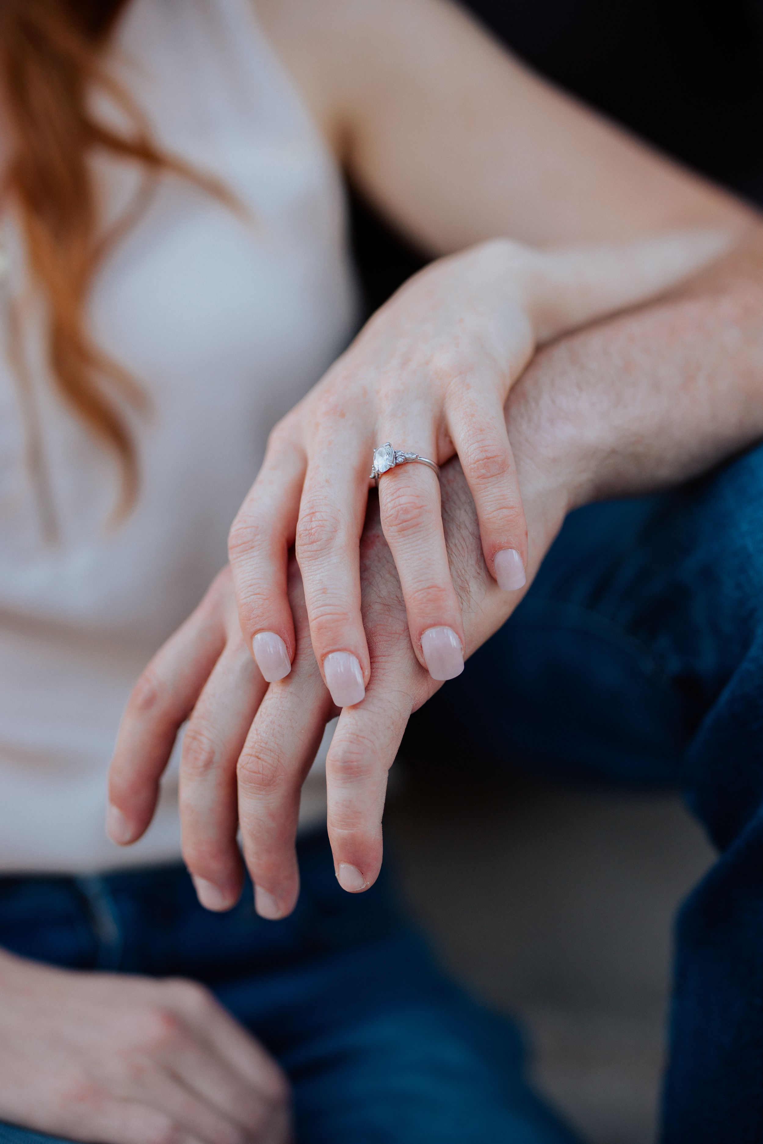A series of photos showing hands with a glittering engagement ring, highlighting the sparkly solitaire diamond from different angles.