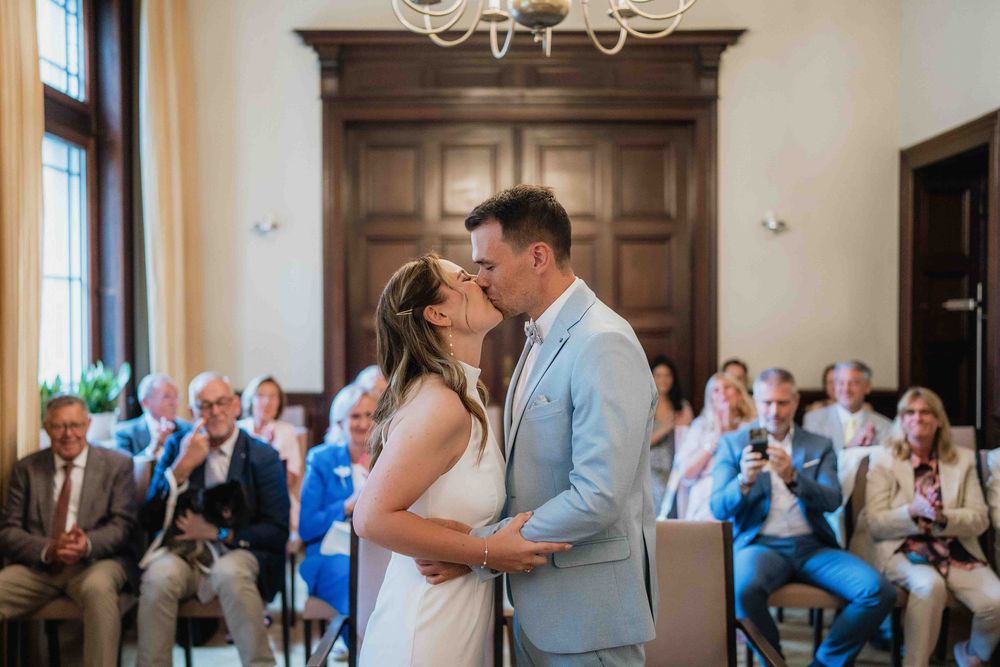 A wedding ceremony taking place in an elegant room with wooden paneling.