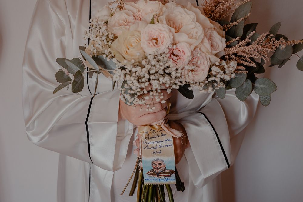Delicate pink and white wedding bouquets with roses and eucalyptus arranged on a light surface.