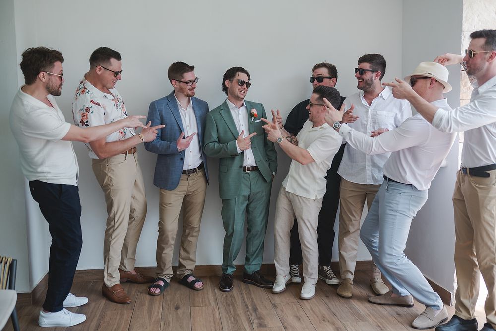 Groomsmen having fun before ceremony at Majestic Elegance Costa Mujeres Riviera Maya photographer.