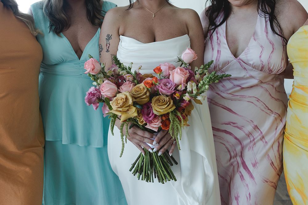 Closeup of bridesmaids holding bouquets Majestic Elegance Costa Mujeres Riviera Maya wedding photography.
