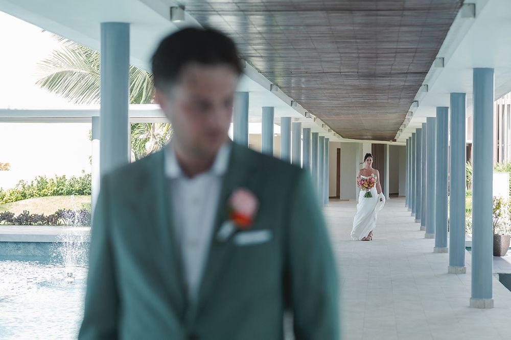 Bride and groom first look moment Majestic Elegance Costa Mujeres Riviera Maya wedding photographer.