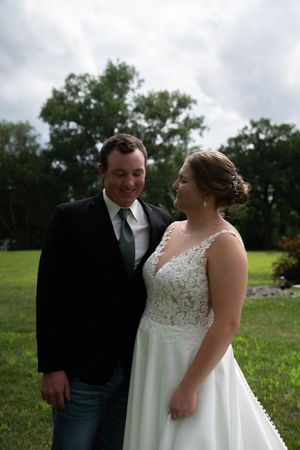 Couple sharing a joyful moment together during their outdoor wedding.