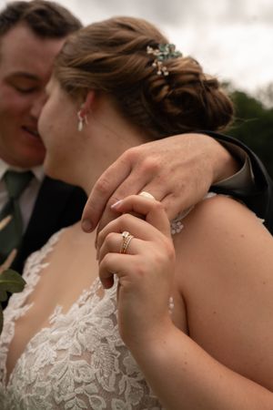 Close-up of wedding rings and jewelry details during an intimate moment.