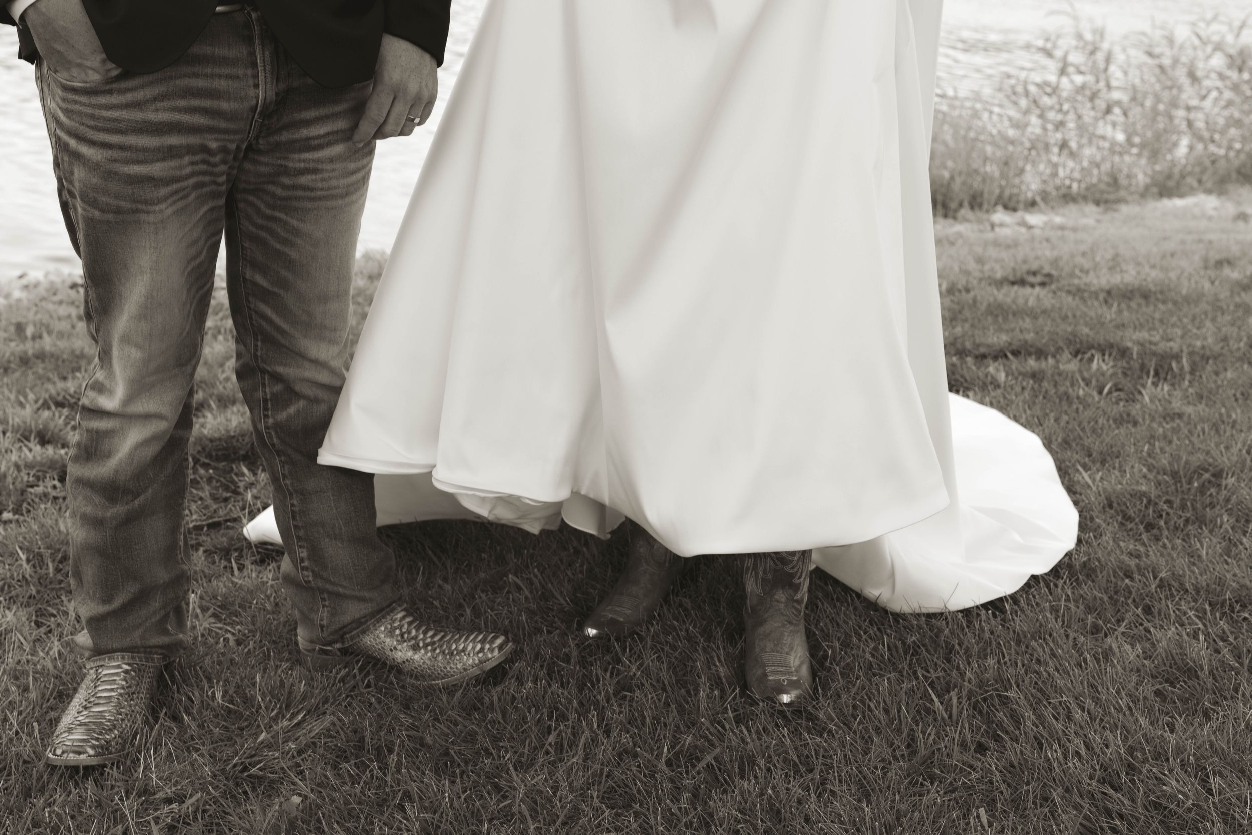Wedding party members shown from waist down in formal attire on grass.