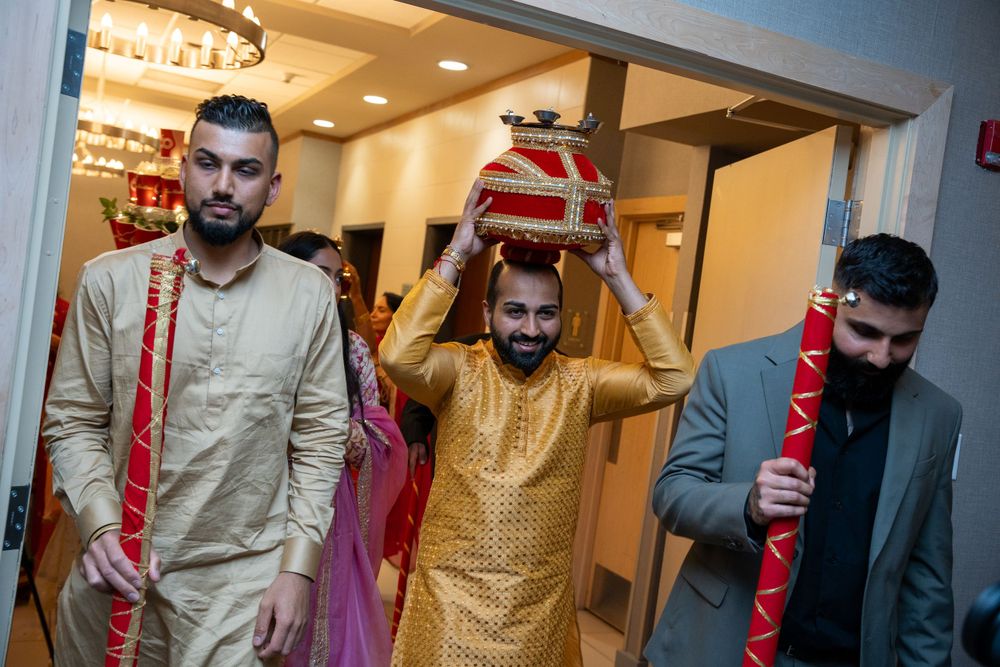 Traditional wedding ceremony participants carrying ceremonial items during celebrations.
