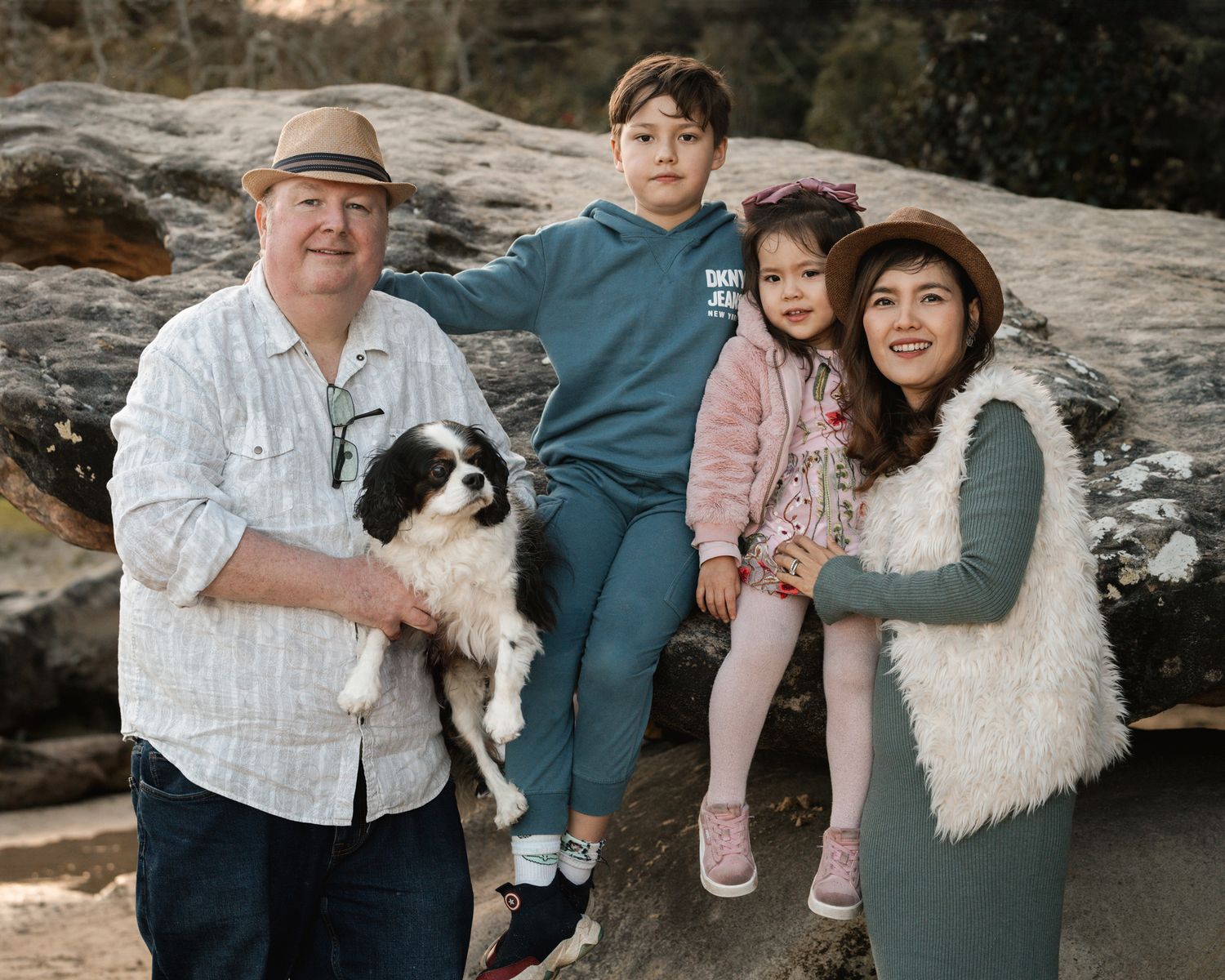 Family of four joyfully posing with their cavalier dog during a family photoshoot at Clifton Gardens in Mosman, Sydney