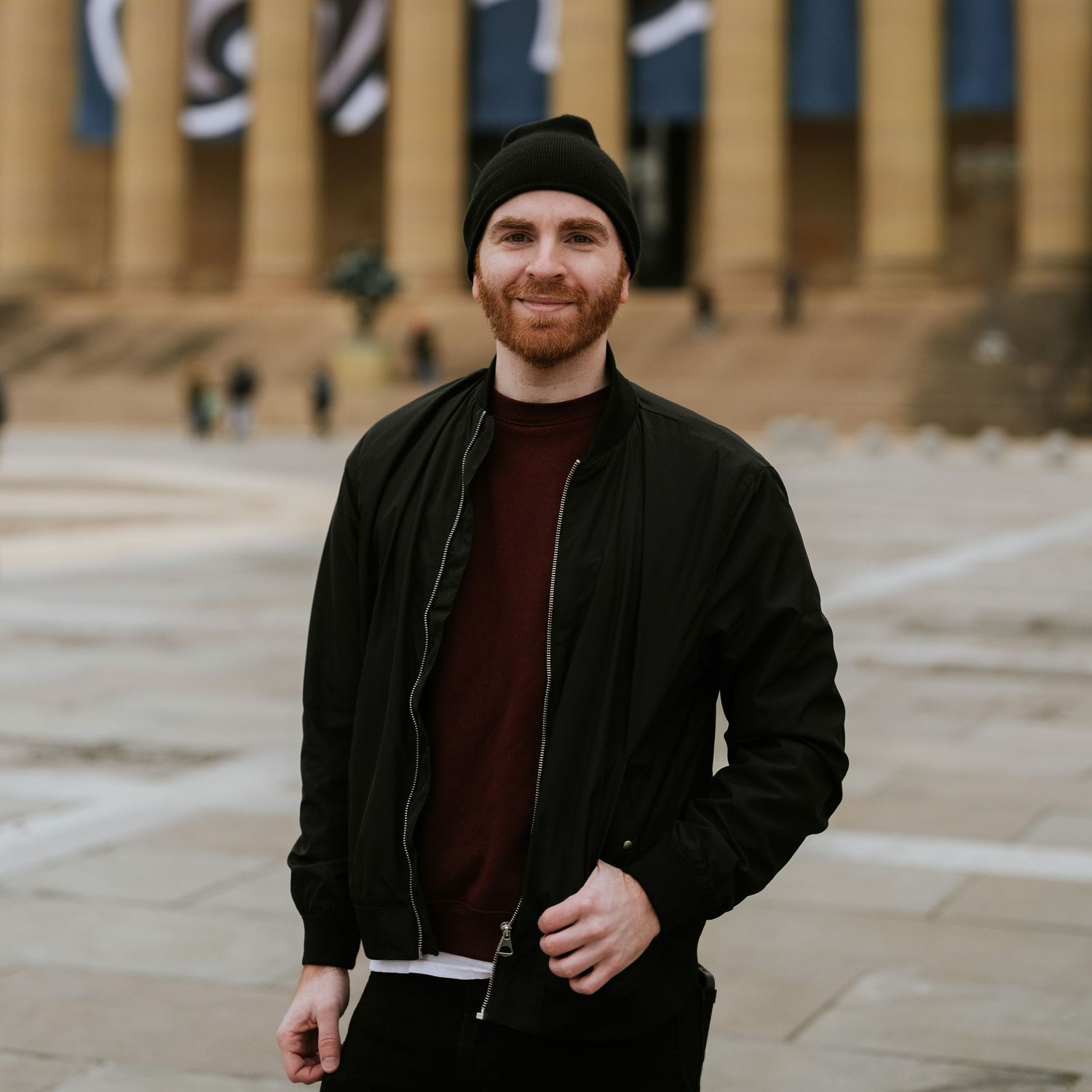 Zach Blum Photographer, aka Zach Blub, stands confidently at the Philadelphia Museum of Art—capturing love stories across Philly, PA.