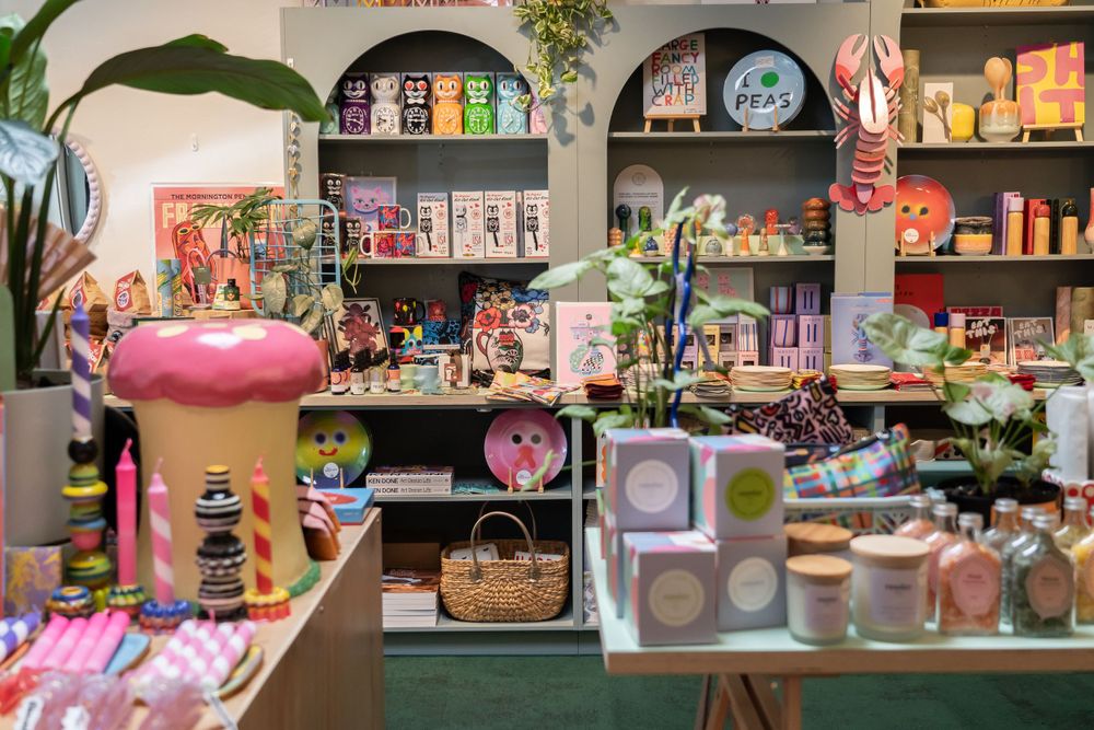 Colorful retail display showcasing cute stationery, toys and home accessories in a whimsical boutique setting.