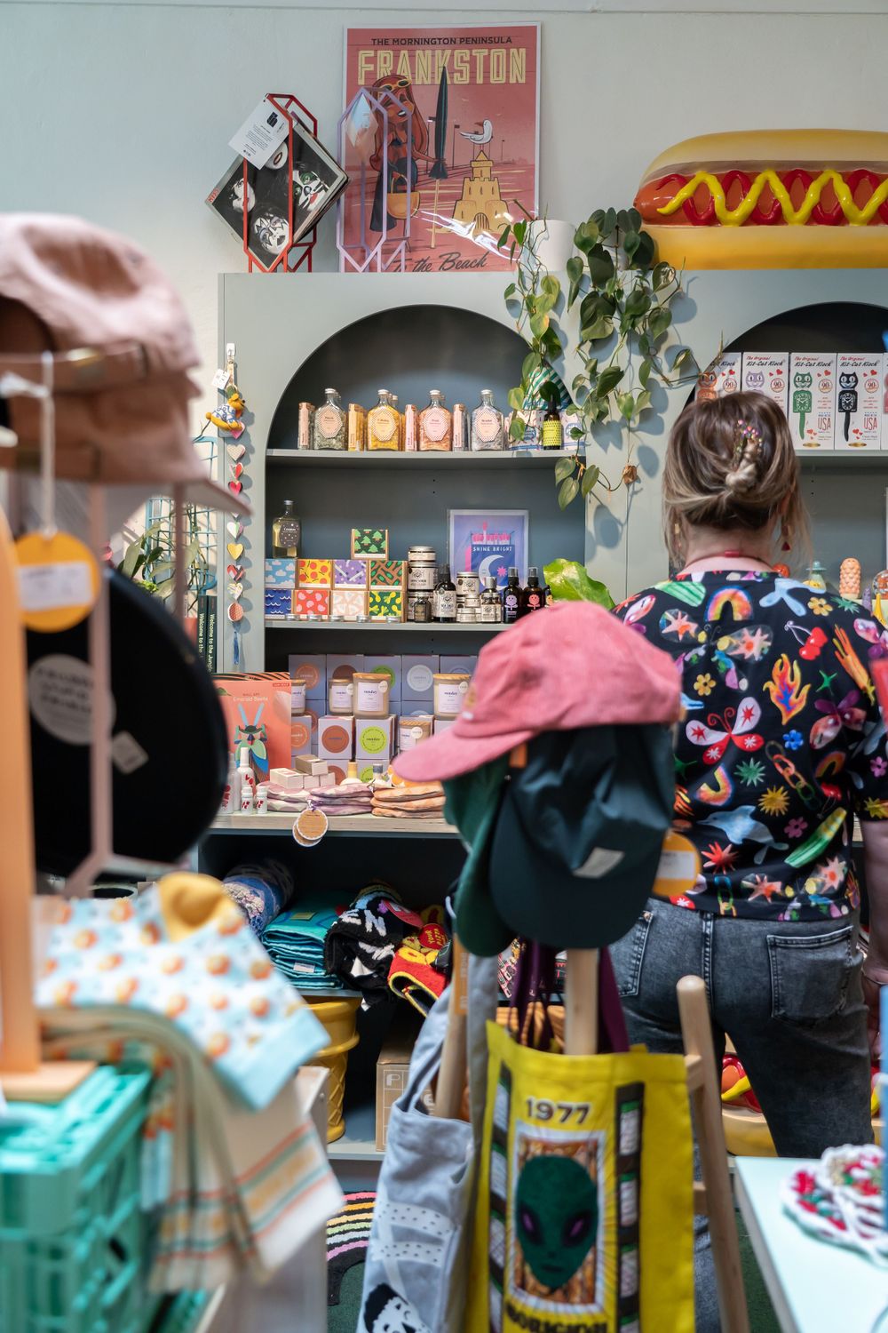 Interior view of a gift shop with arched shelving displaying various retail items and decor.
