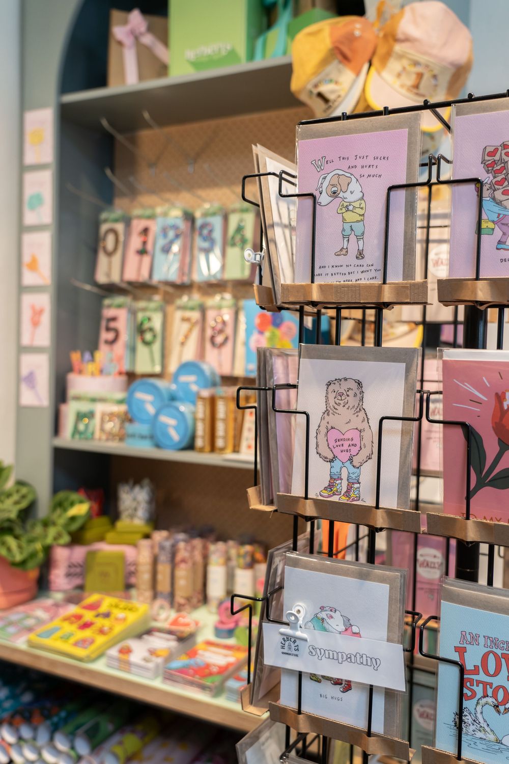 Close-up of greeting cards and stationery displayed on a rotating card rack in a gift shop.