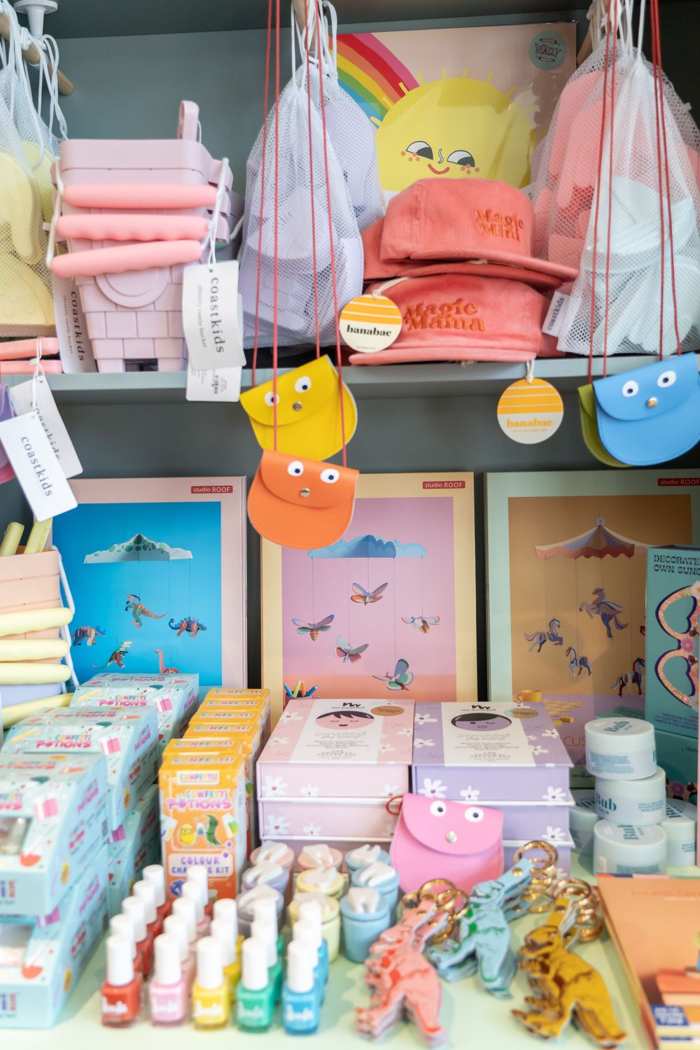 Cute plush toys and colorful merchandise displayed on retail shelves with pastel-colored packaging.