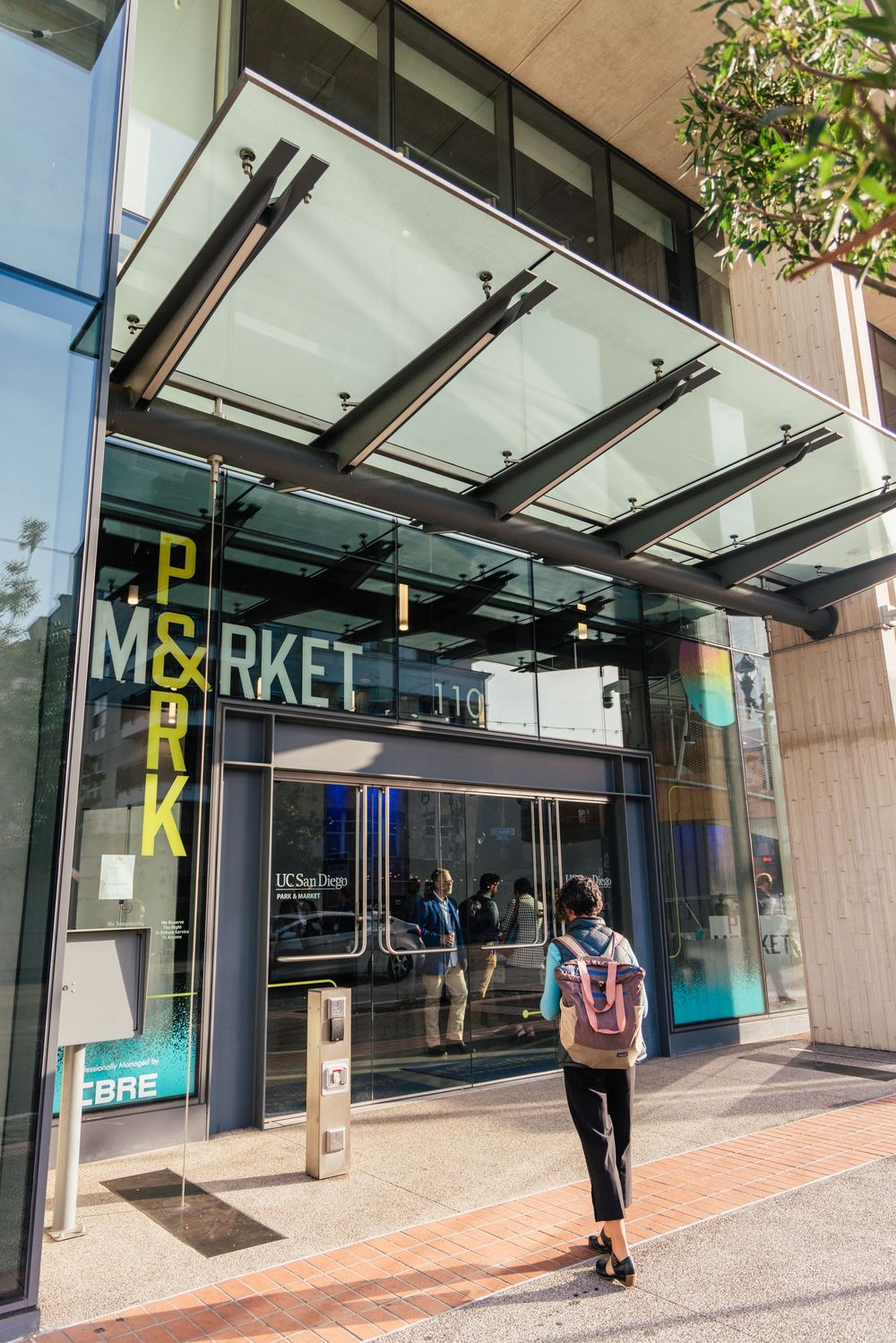 Empty storefront with glass windows and entrance showing closed retail space in an urban shopping area.