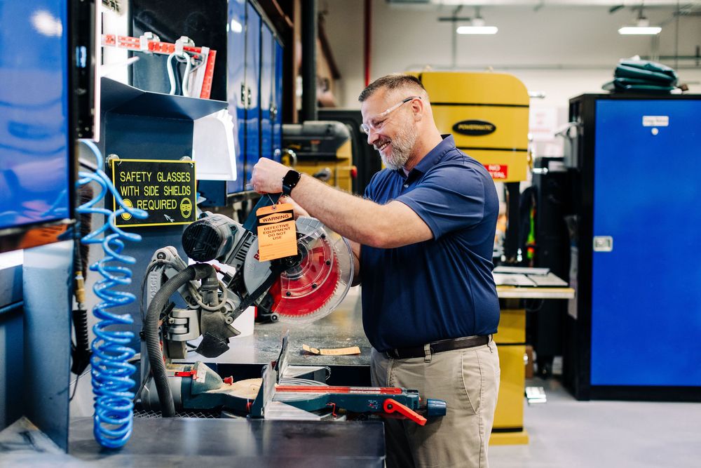 Auto mechanic inspecting car brake system during routine maintenance service at repair shop.
