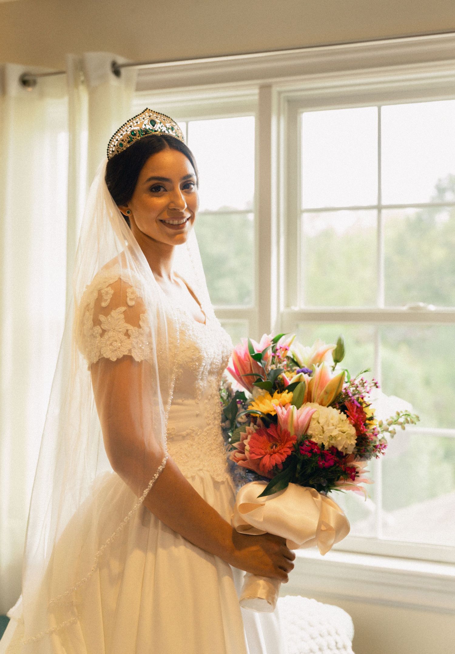 A sequence of bridal portraits showing a white dress and colorful bouquet near sunny windows.