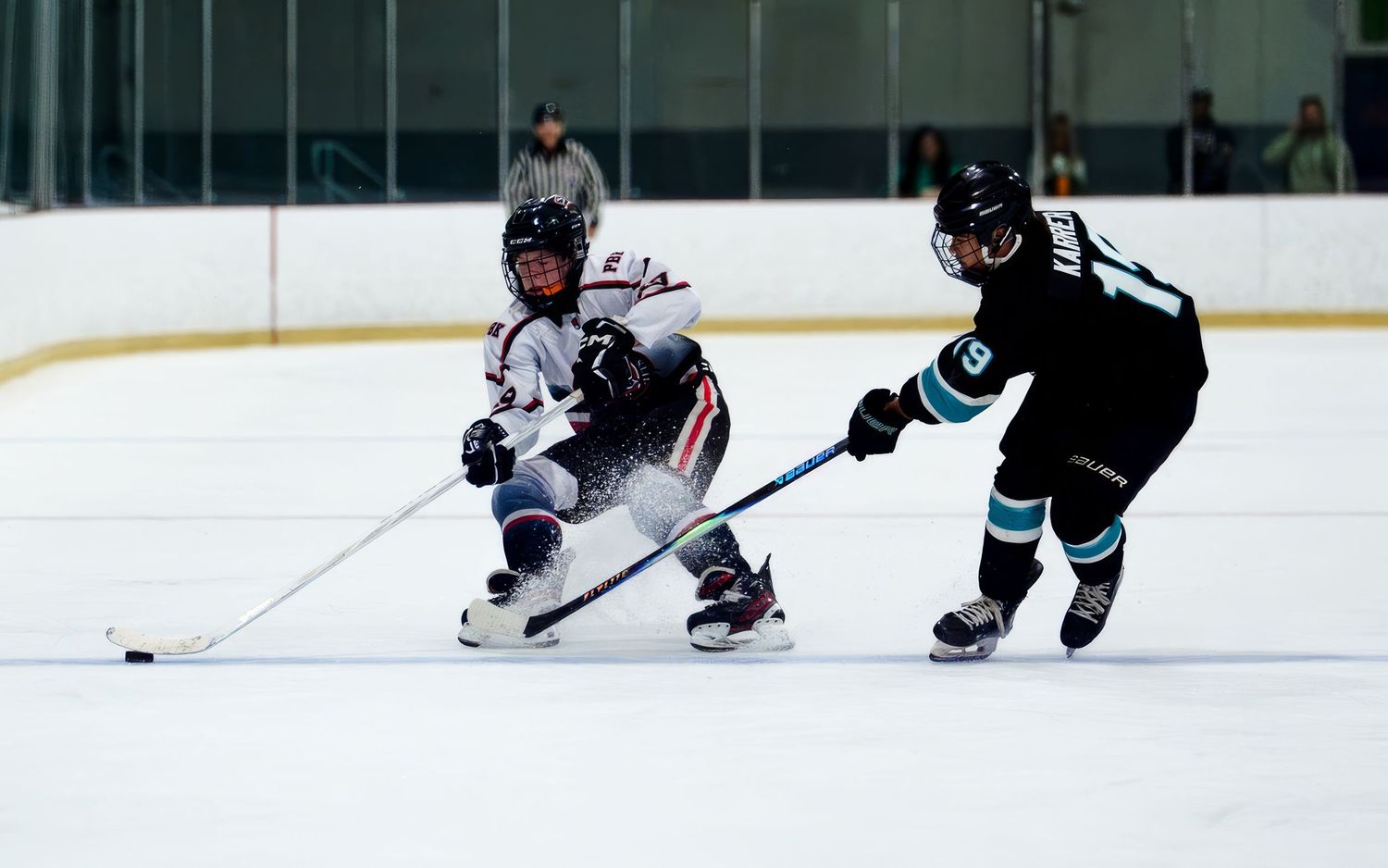Palmyra Black Knights hockey player chasing puck during game action at York Ice Arena, York PA, by SportsFox Photography