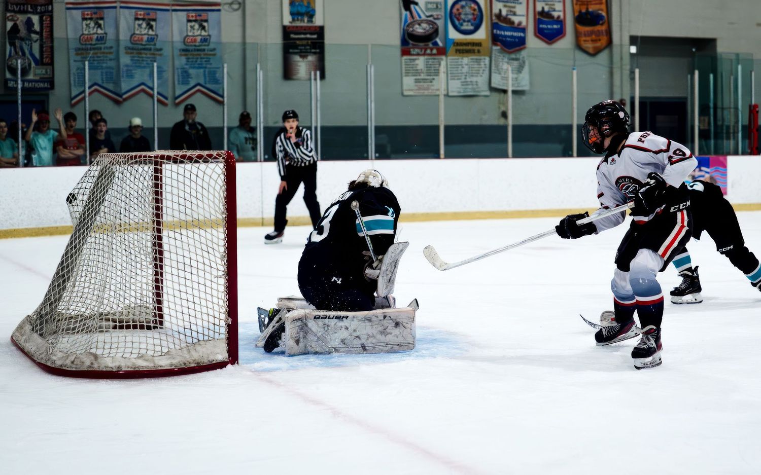 Palmyra Black Knights goalie making a save with defender, York Ice Arena, York PA, by SportsFox Photography