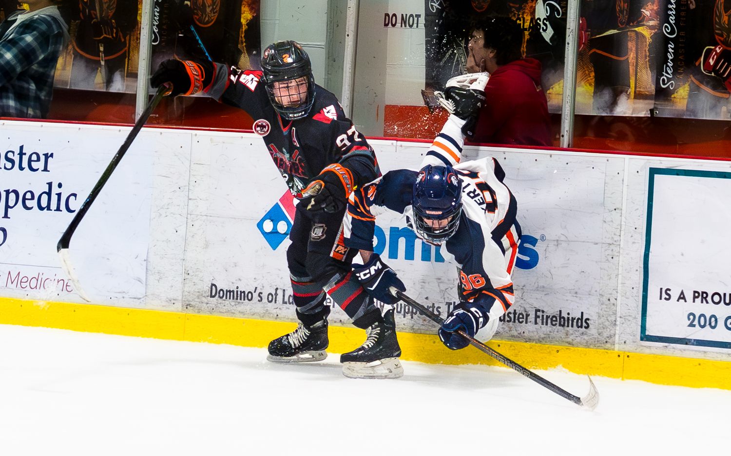 Hershey Trojans hockey players battling for puck along the boards at Klick Lewis Arena, Palmyra PA, by SportsFox Photography