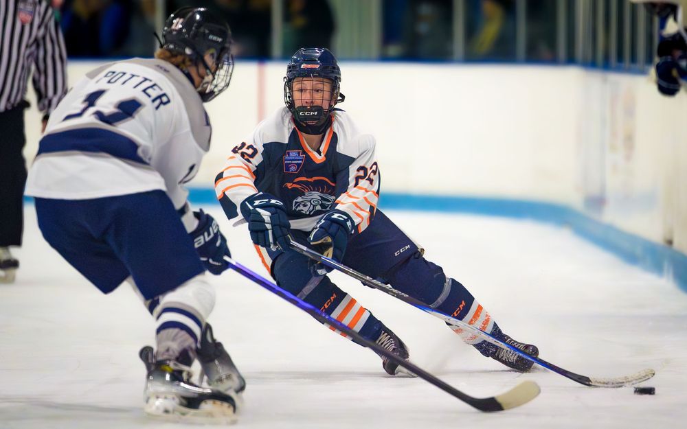 Hershey Trojans hockey players battling for puck, intense game action at Klick Lewis Arena, Palmyra PA, by SportsFox Photography