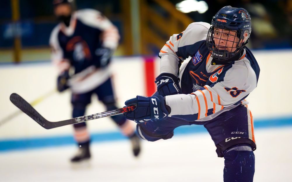 Hershey Trojans hockey player taking a slapshot during game at Klick Lewis Arena, Palmyra PA, by SportsFox Photography