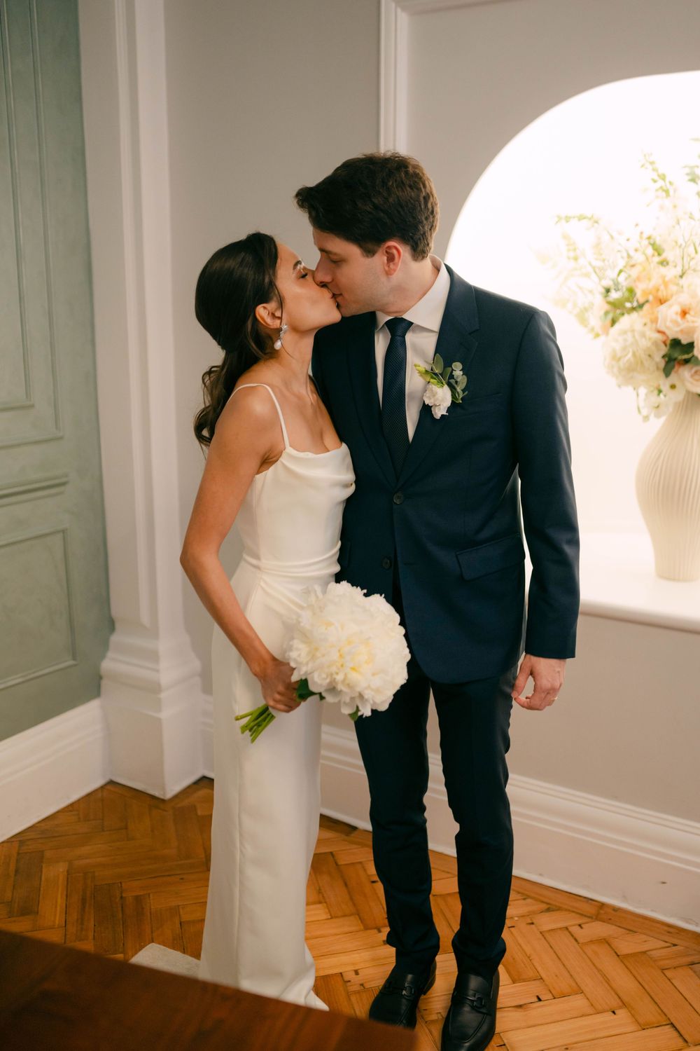 Series of romantic wedding moments showing a couple in white dress and dark suit against a light backdrop.