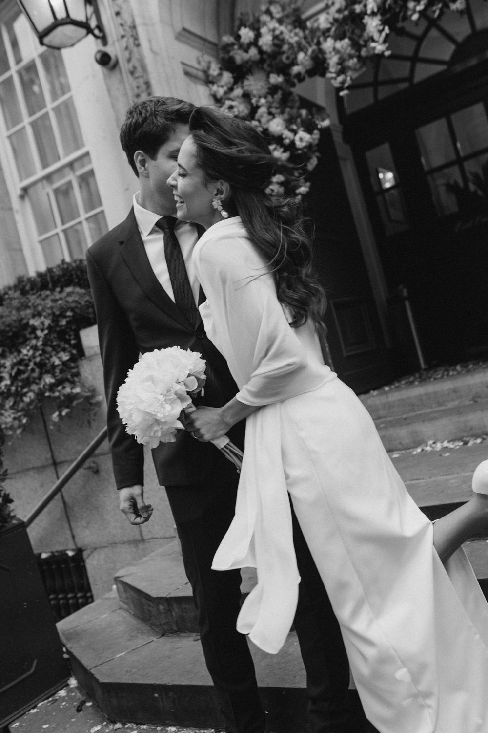 Black and white series of romantic wedding moments captured in an elegant outdoor setting.
