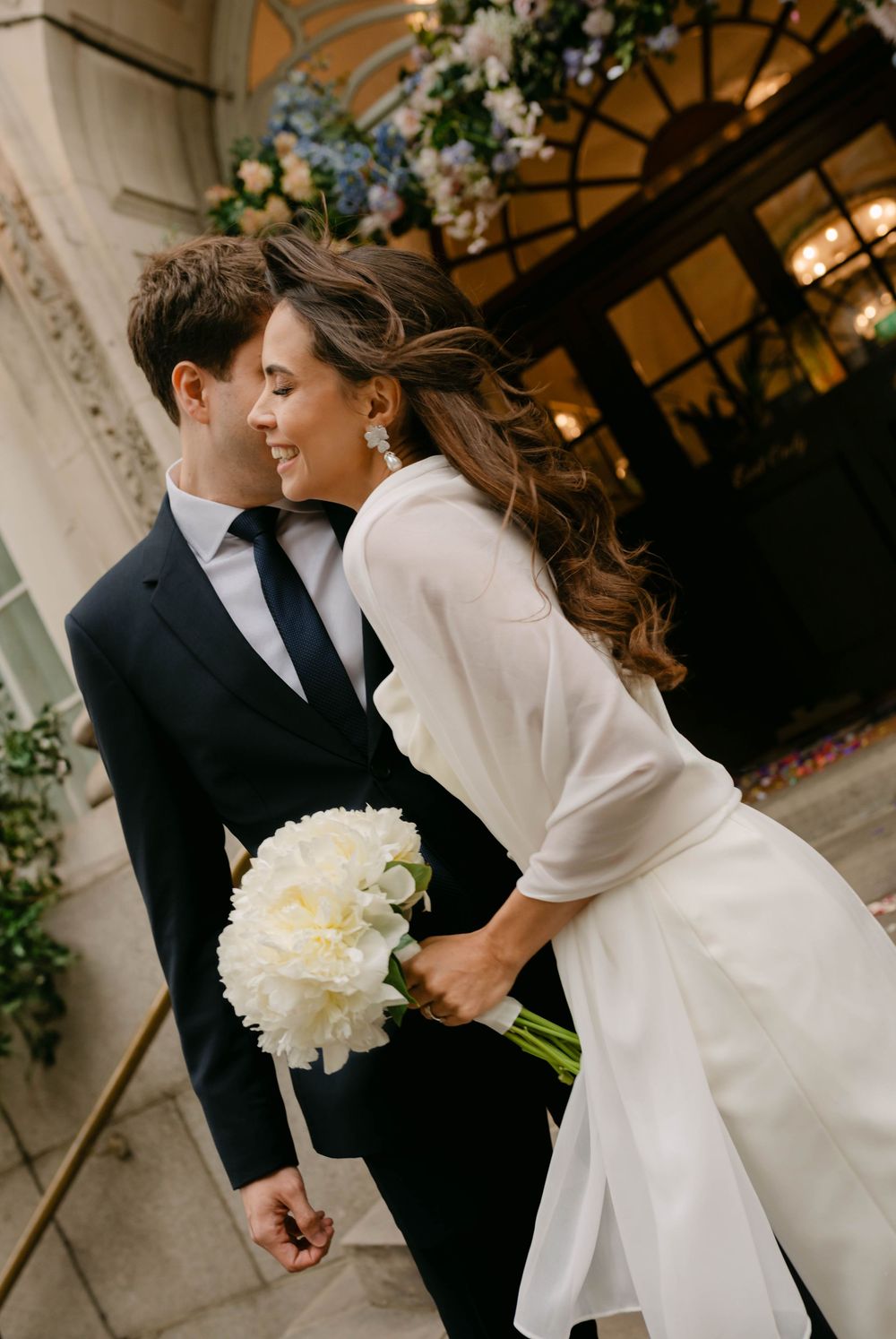 Romantic wedding photo sequence showing couple with white bouquet against stone architecture.
