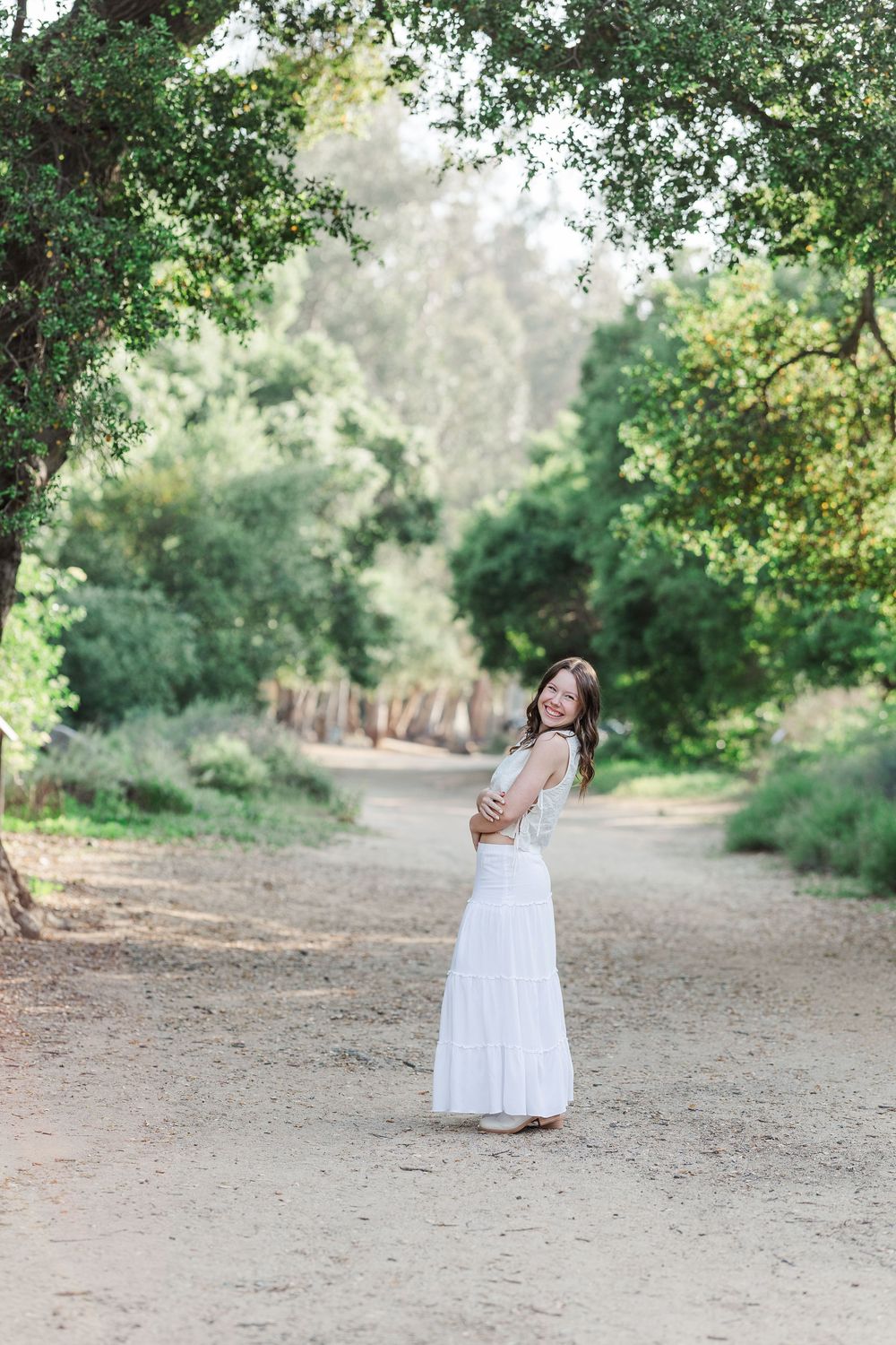 Outdoor senior photo session with winter greenery