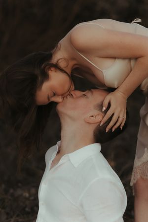 Romantic couple sharing intimate moments in artistic black and white portrait series.