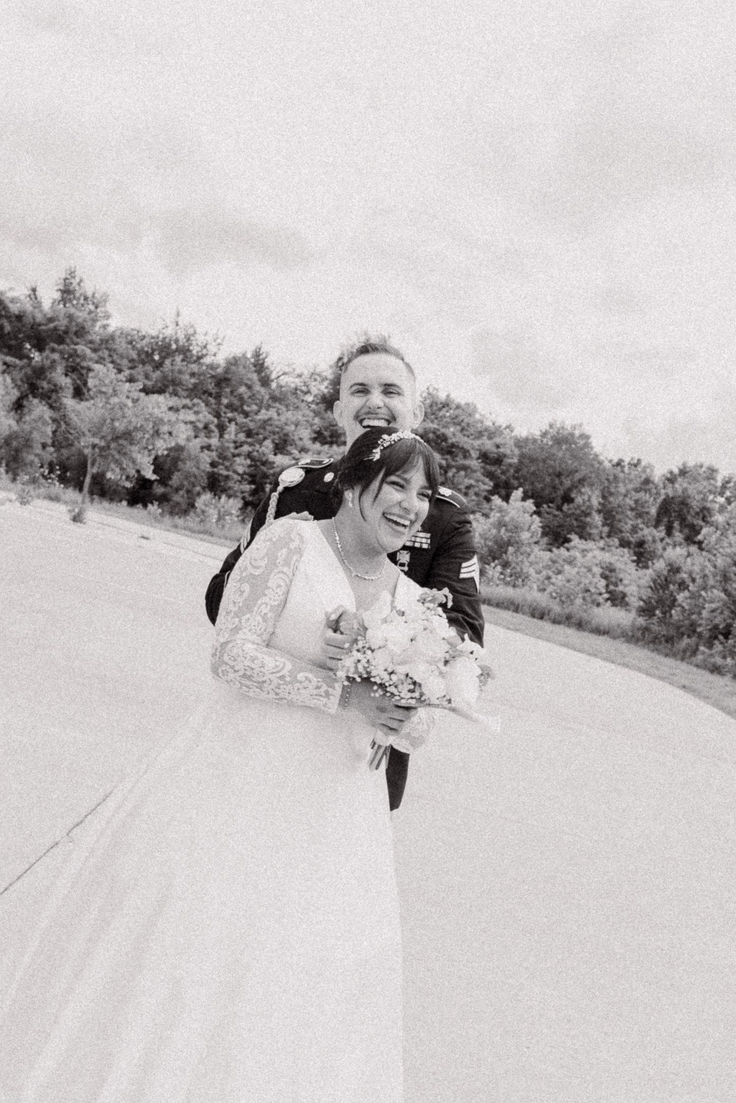 Black and white wedding photos showing a couple embracing in a natural outdoor setting during wedding photoshoot.