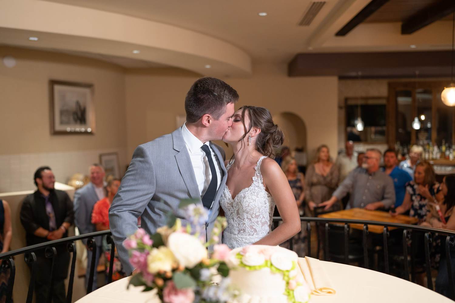 Wedding reception guests enjoy a celebration  cutting the cake at the club at corazon