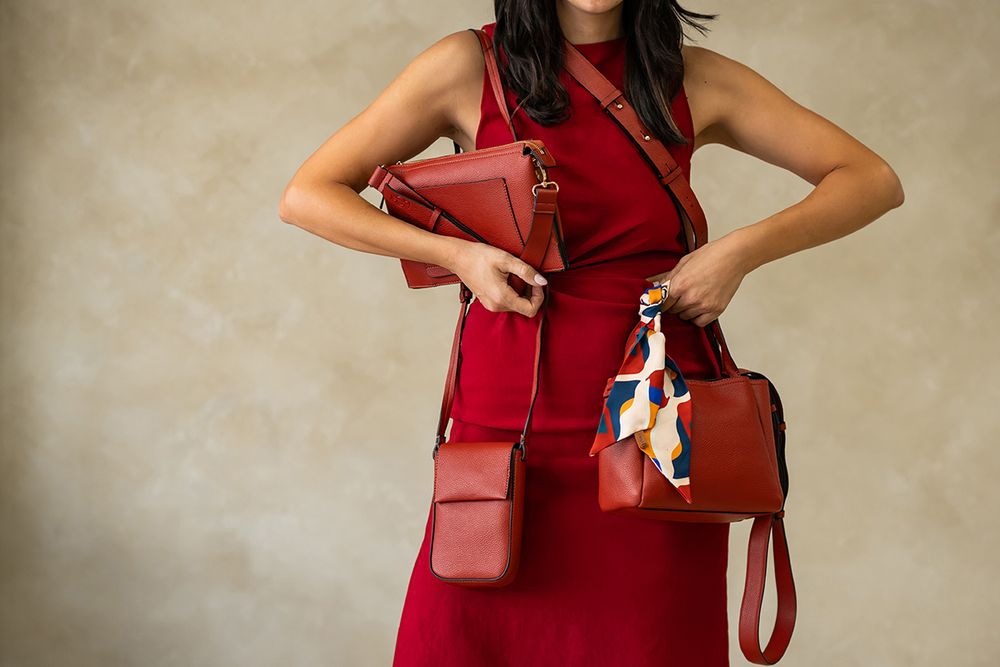 Woman in red dress showing various poses with brown leather crossbody bag against beige background.