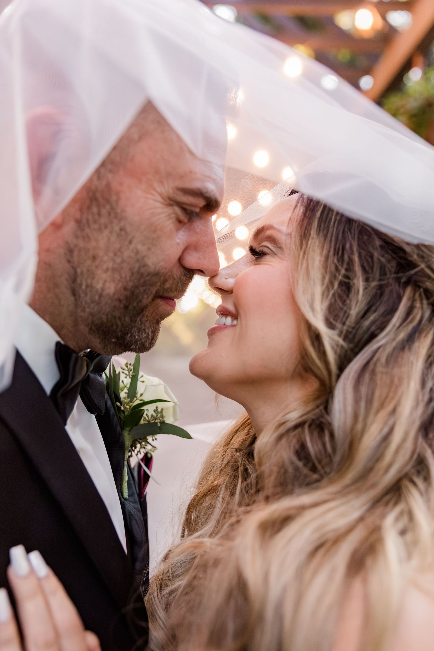 A romantic wedding portrait sequence showing a tender moment between newlyweds under soft lighting.