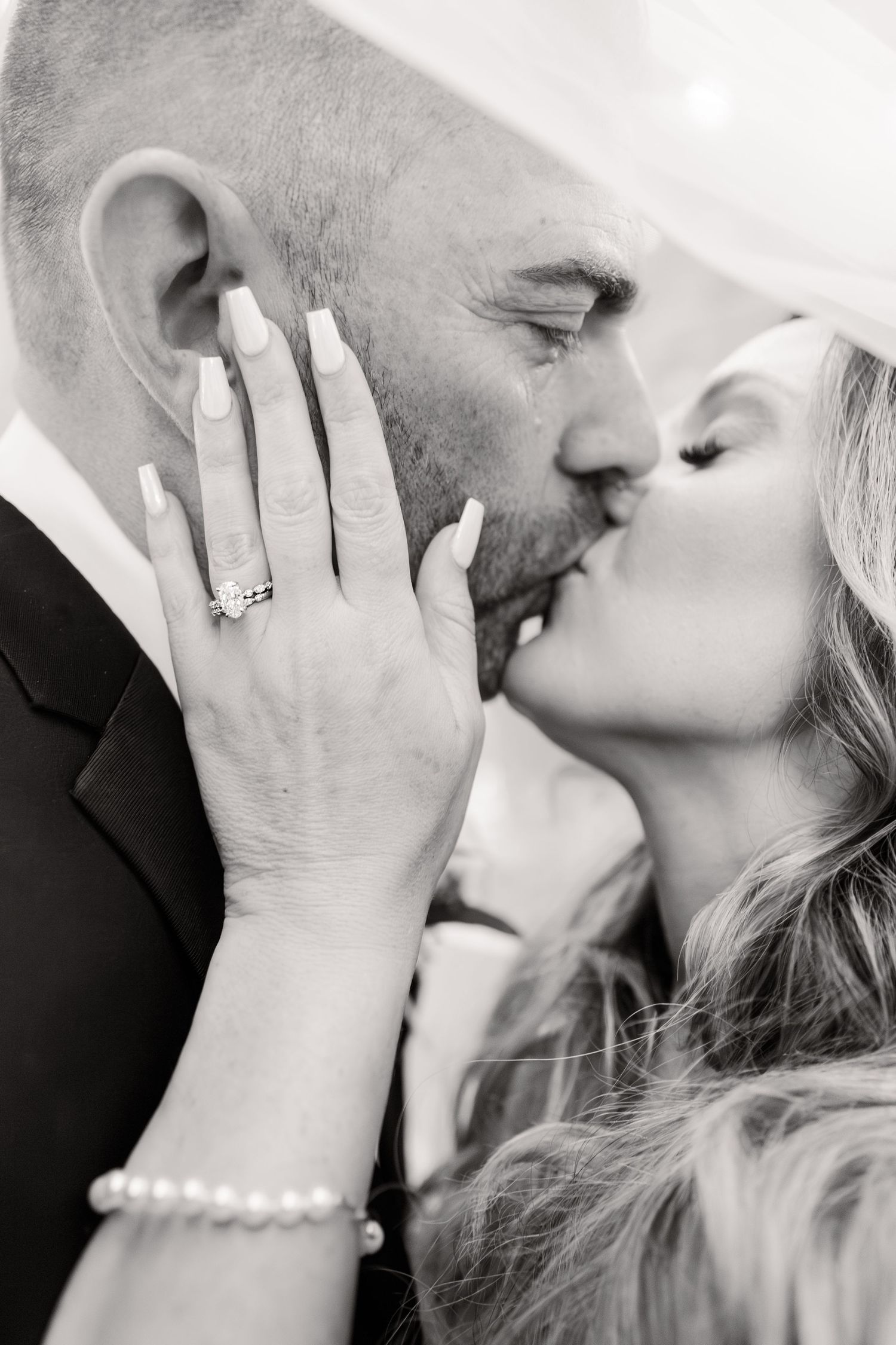 Black and white wedding photos capturing intimate close-up moments between the bride and groom.