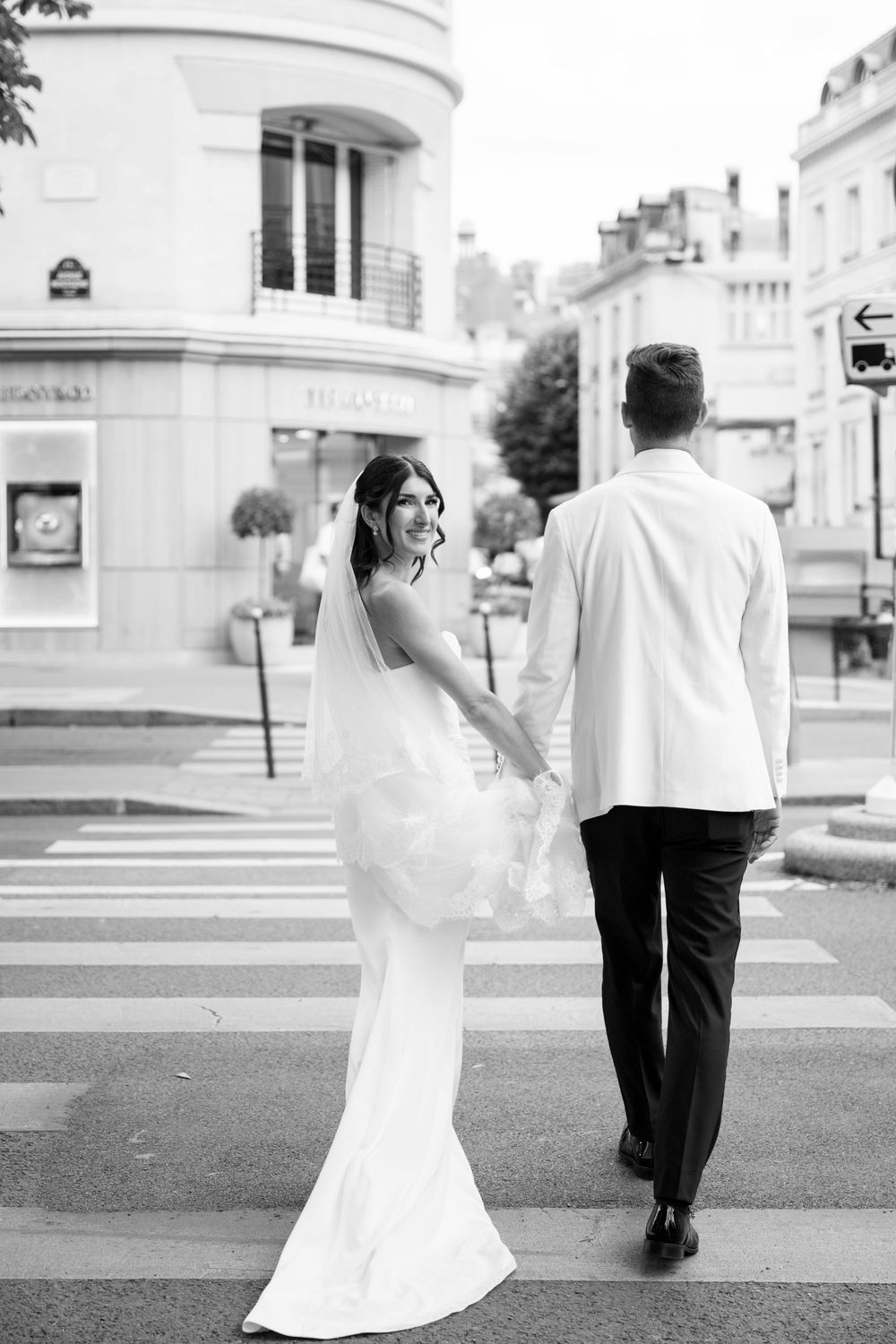 A black and white photo sequence shows a couple walking across a street, with the bride's dress flowing in the breeze.