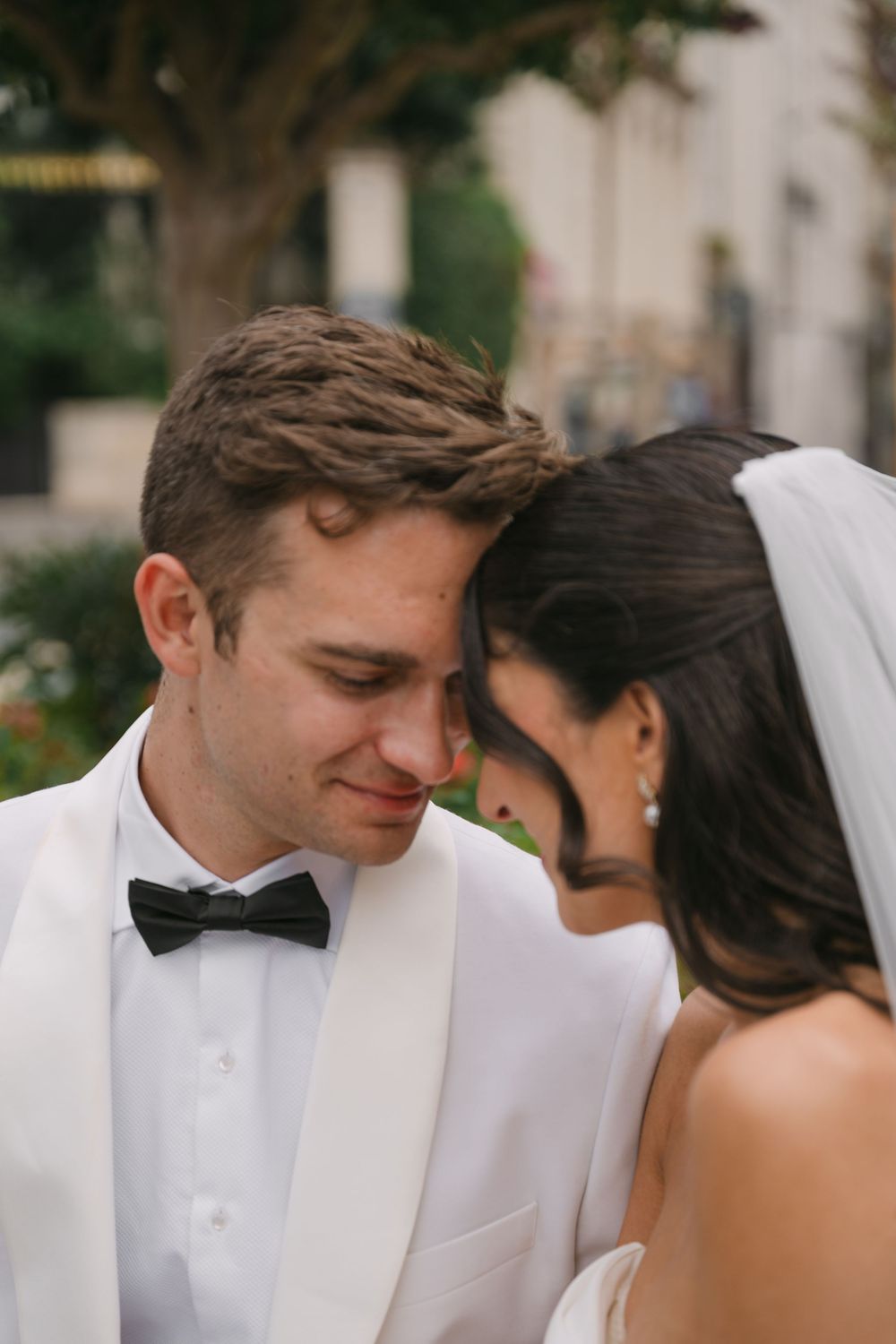A bride and groom share an intimate moment in a series of candid wedding photos showing them leaning close together.