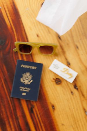 A sequence of photos showing a US passport and travel documents laid out on a wooden surface.
