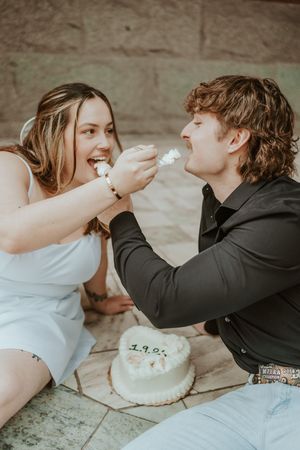 Playful cake smashing sequence showing couple feeding each other dessert.