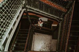 Industrial metal staircase and lattice work photographed from below.