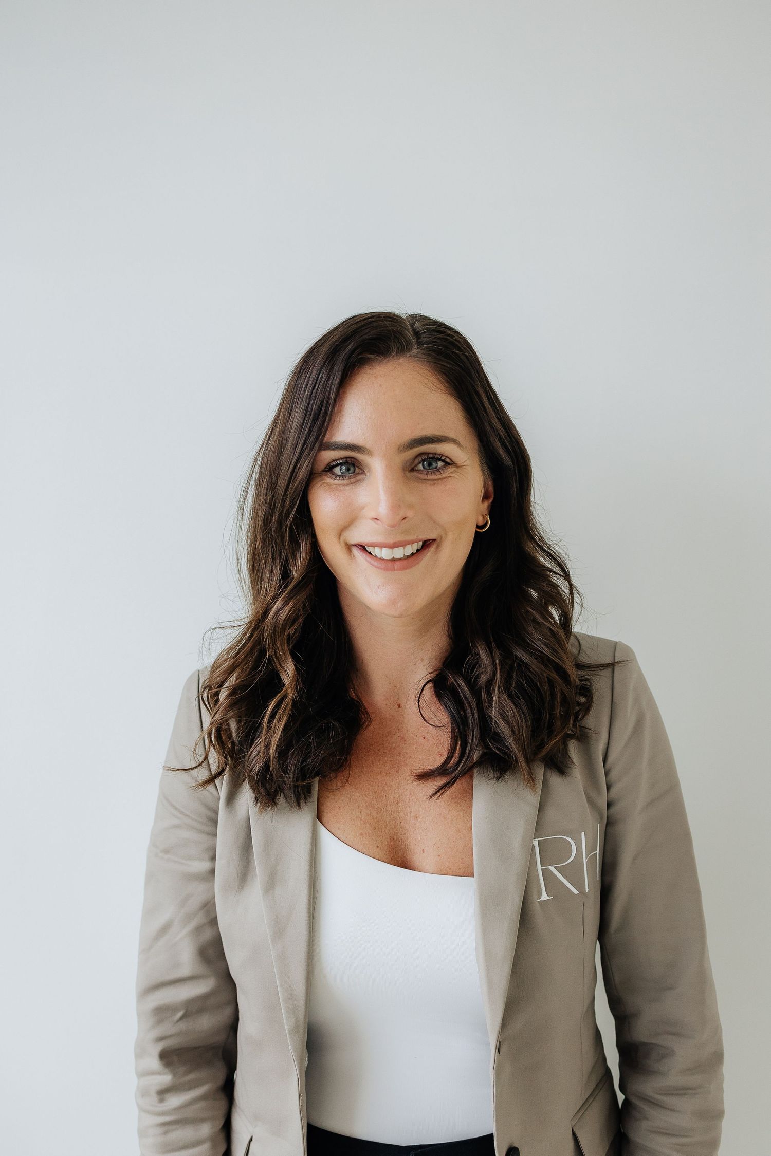Professional portrait series showing a person in a beige blazer and white top against a light background.
