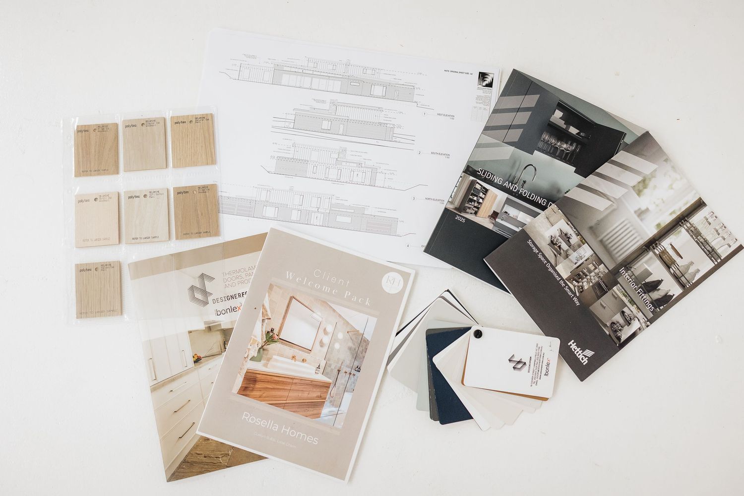 Interior design mood board with material samples and photographs arranged on white background.