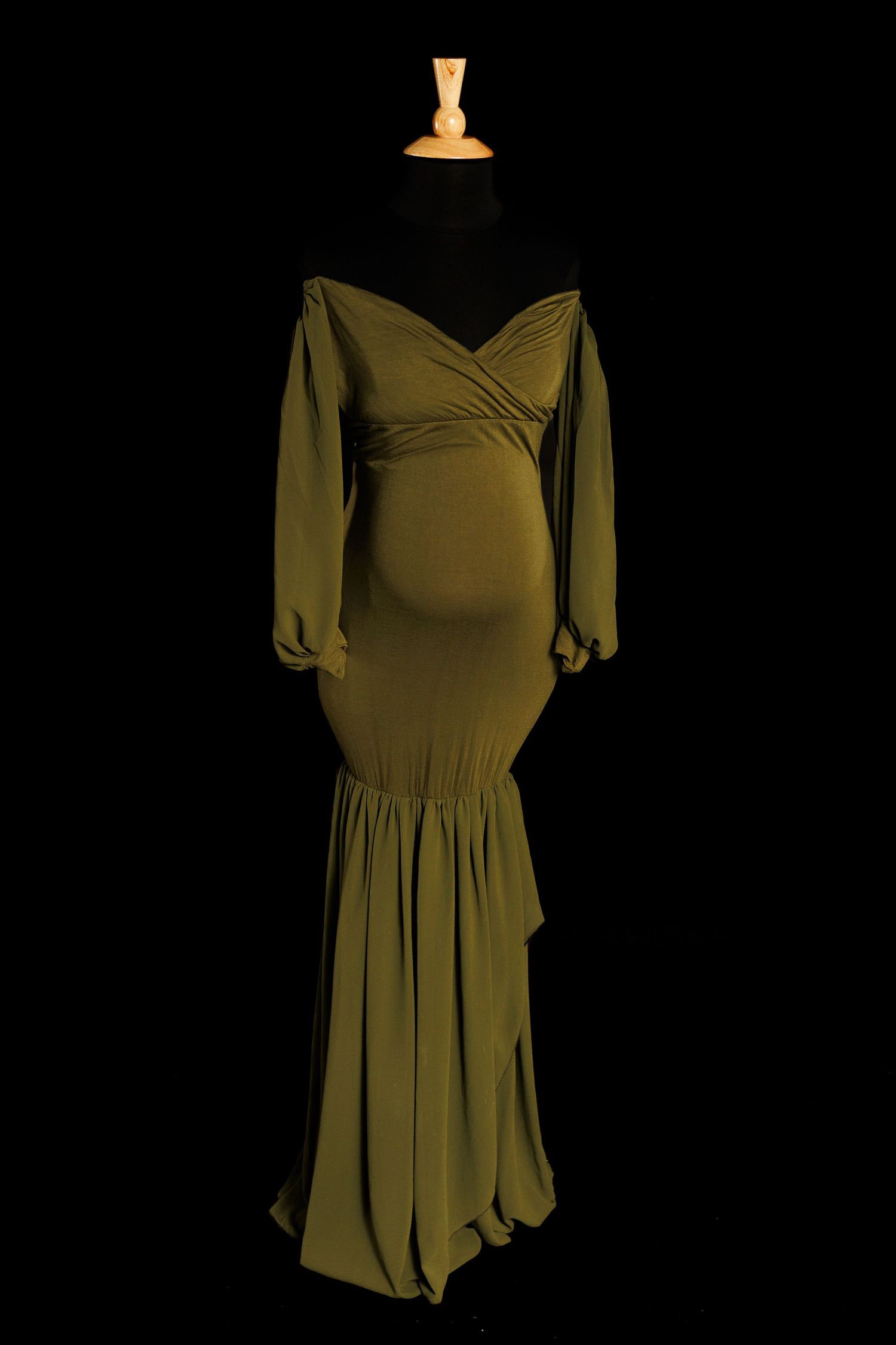 A vintage olive green dress with puff sleeves and pleated skirt displayed in multiple angles on a dark background.