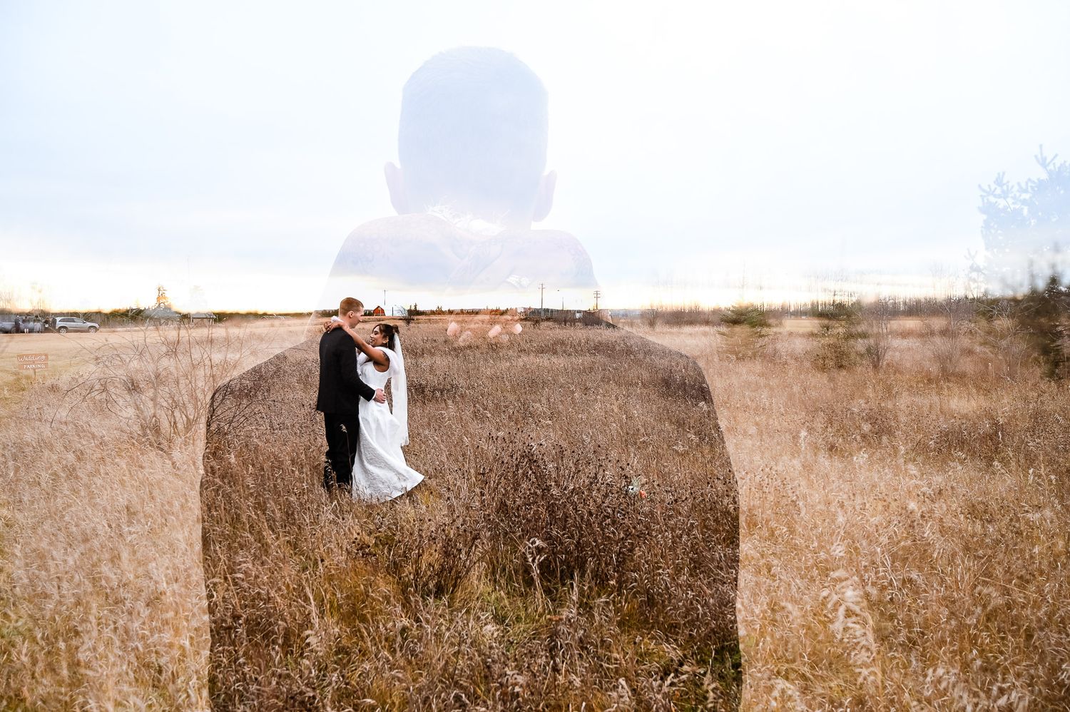 A groom in  tall brown grass an autumn field holding his  indian wife. white fur and veil, dress with embroidery pattern, bridal portrait.