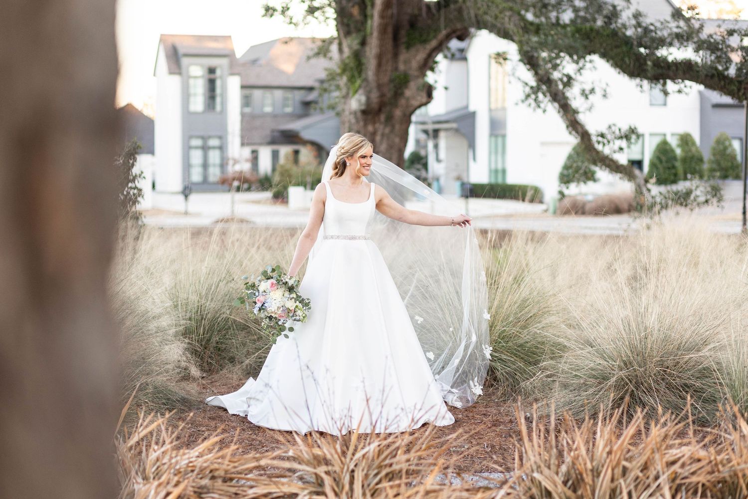 bride in tall grass with veil