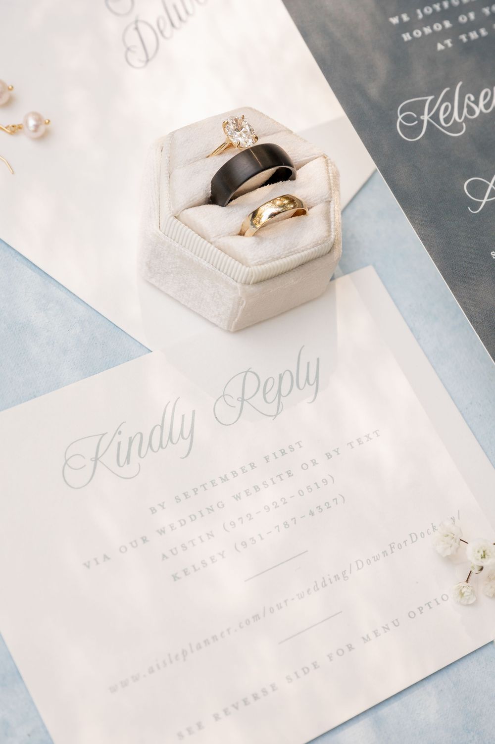 Elegant wedding invitation suite with ring boxes and delicate calligraphy details.