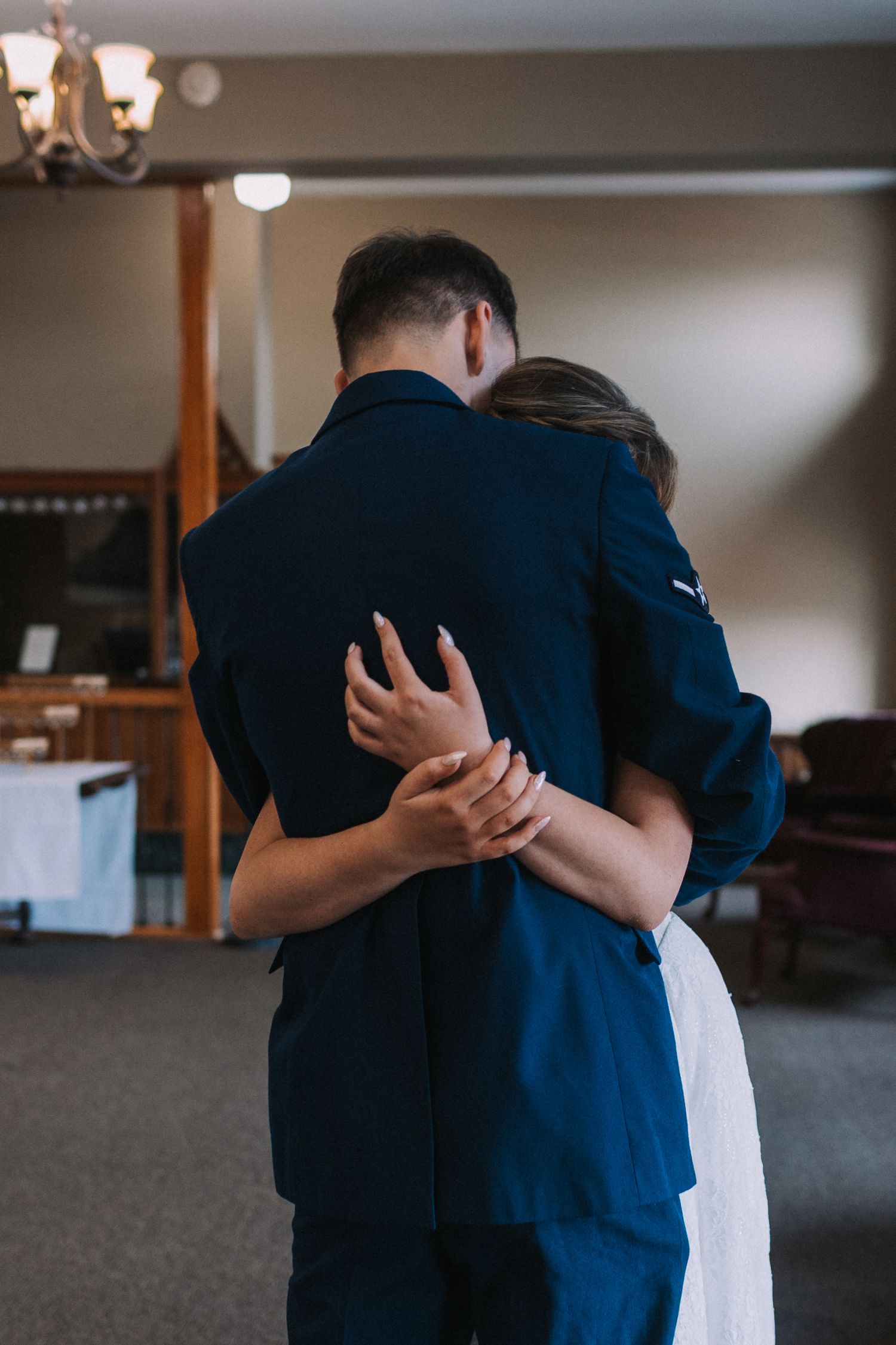 A couple shares an intimate embrace during their first dance at their wedding.