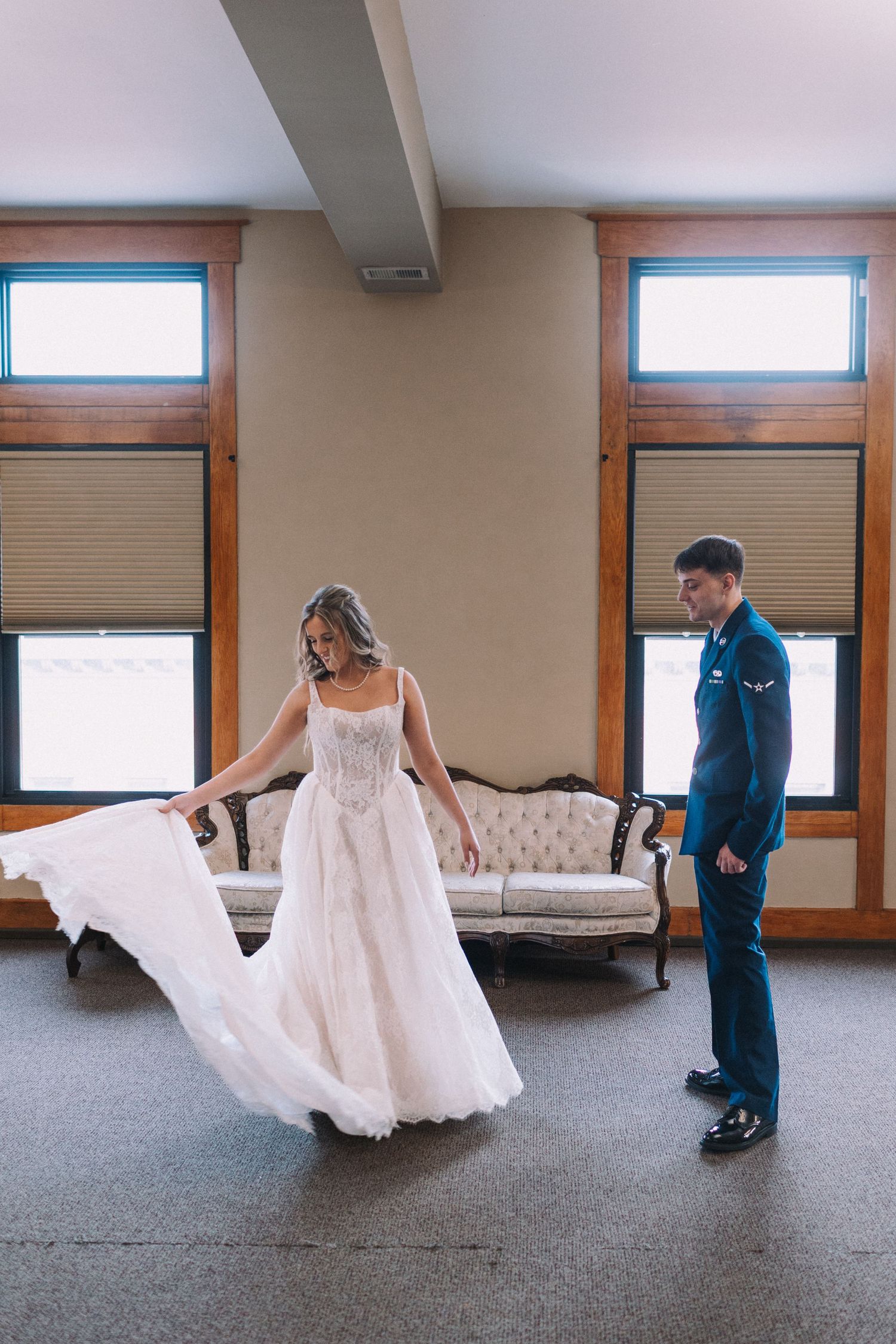 A series of photos showing a bride twirling in her lace wedding dress on grey carpeting.